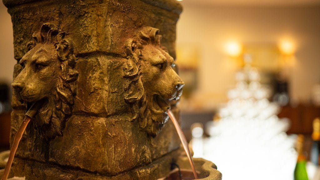 four-headed lion cocktail fountain serving drinks at a reception