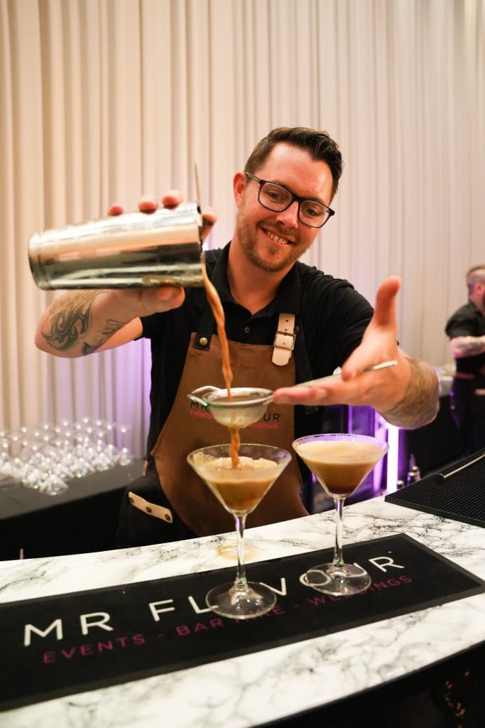 Mr Flavour bartender pouring espresso martinis at a wedding reception bar