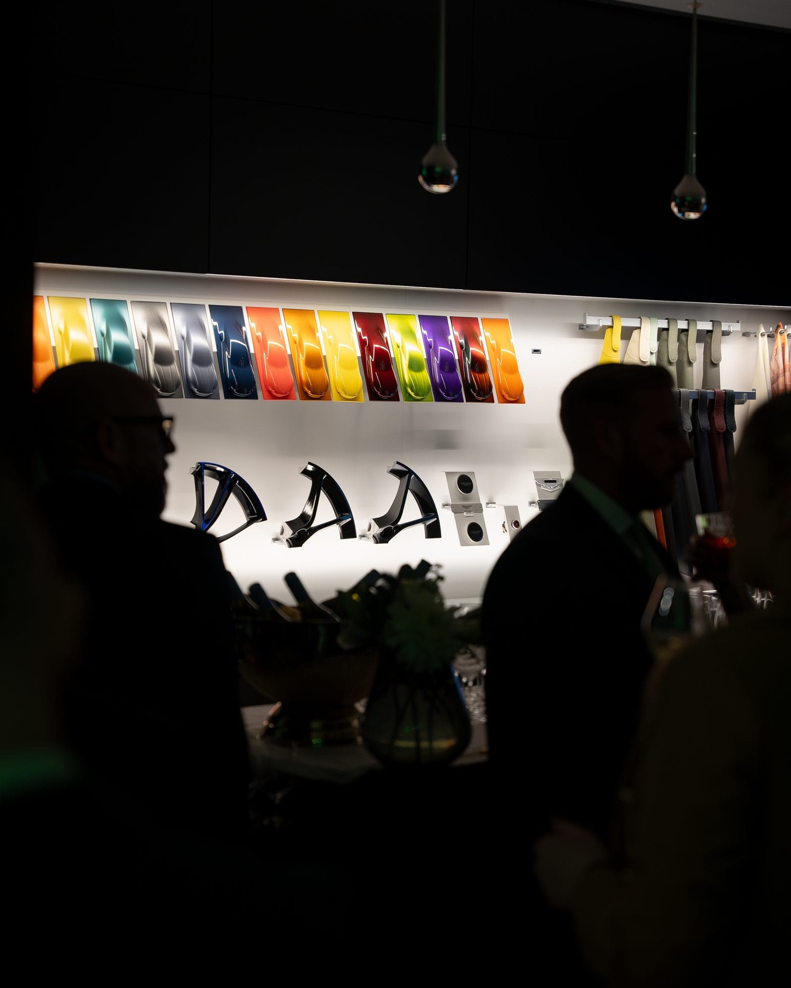 The branded Mr Flavour cocktail bar installed in the Aston Martin showroom, lit in the brand's signature green