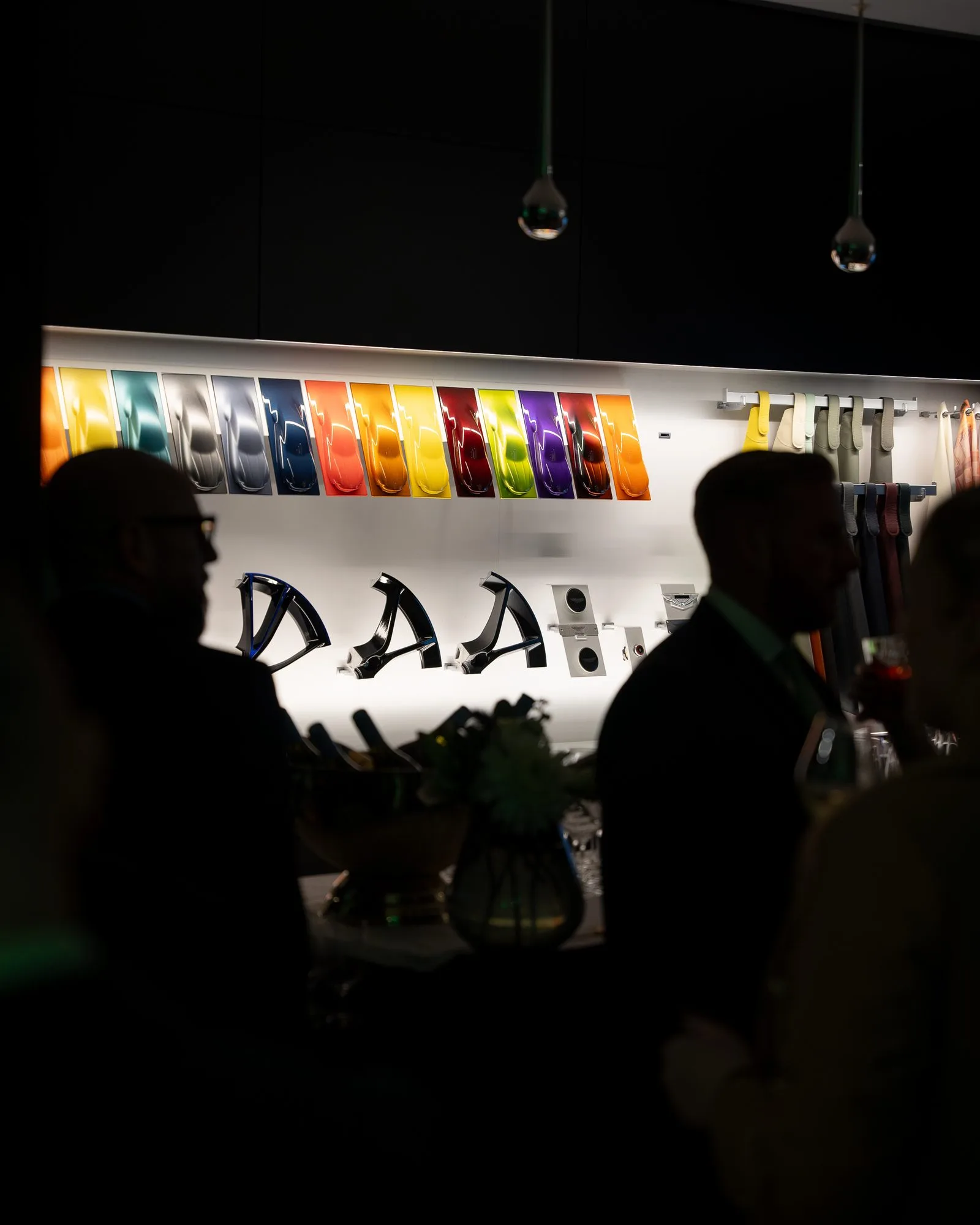 The branded Mr Flavour cocktail bar installed in the Aston Martin showroom, lit in the brand's signature green