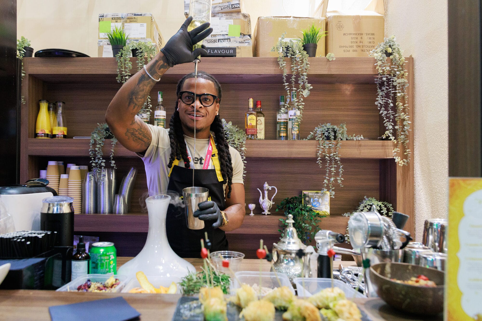 Mr Flavour mixologist in a branded apron preparing a signature drink on the Betfinal Moroccan stand