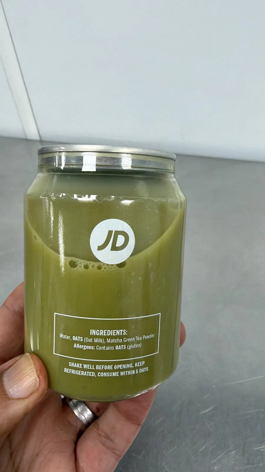 Back label of the branded matcha can showing ingredients, oat allergen note and consume within 5 days instruction