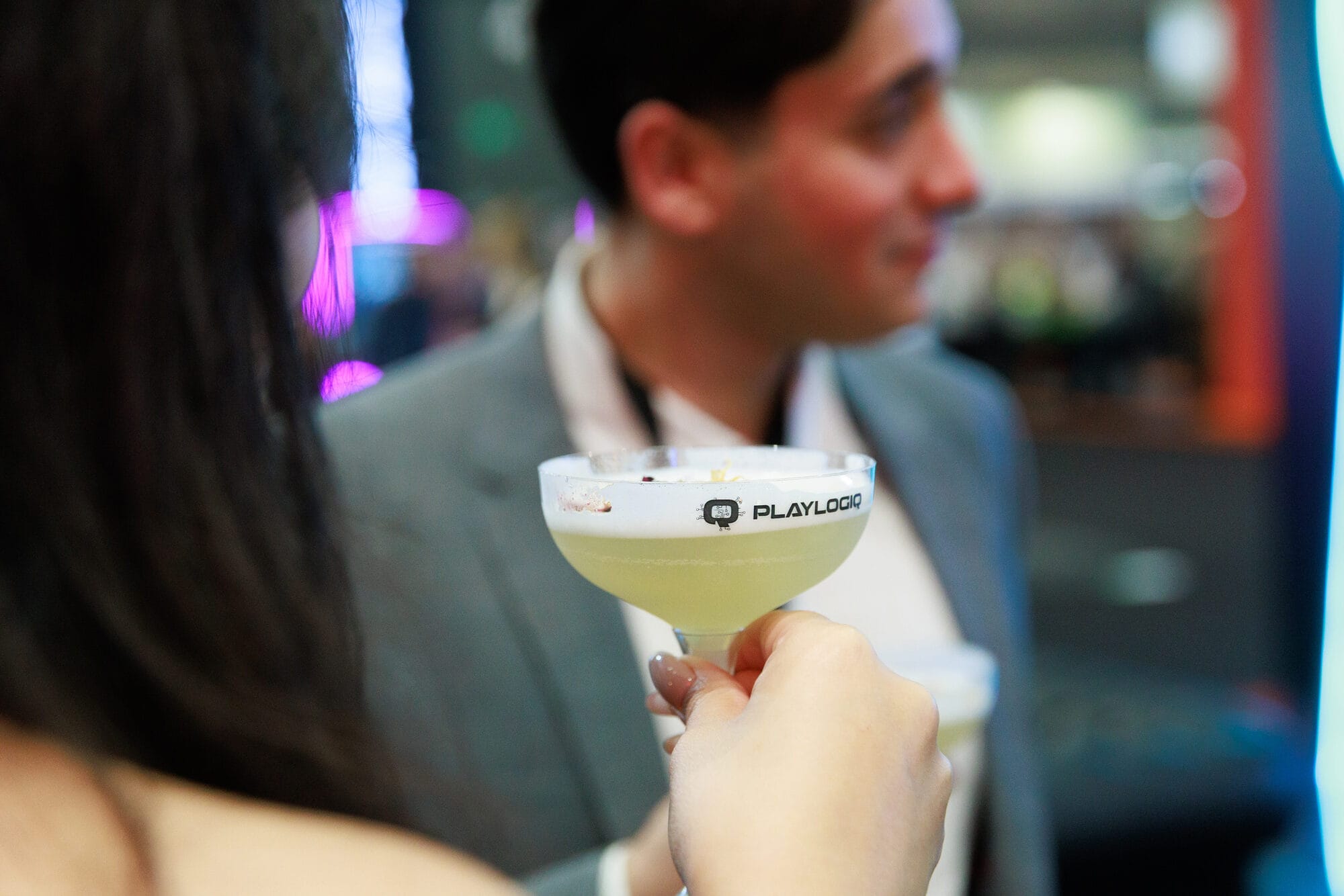 PlayLogiq etched coupe holding a signature cocktail created for the ICE stand