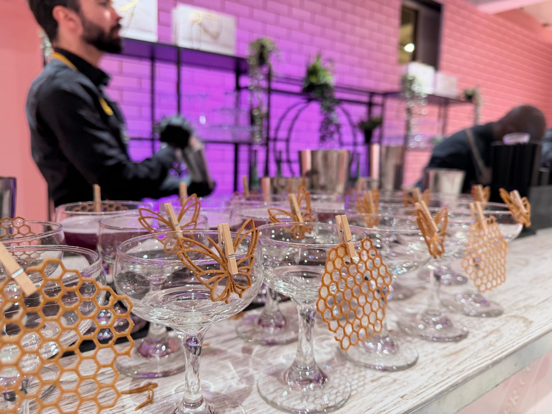 Coupe cocktails with bespoke honeycomb and butterfly garnishes at a P.Louise event