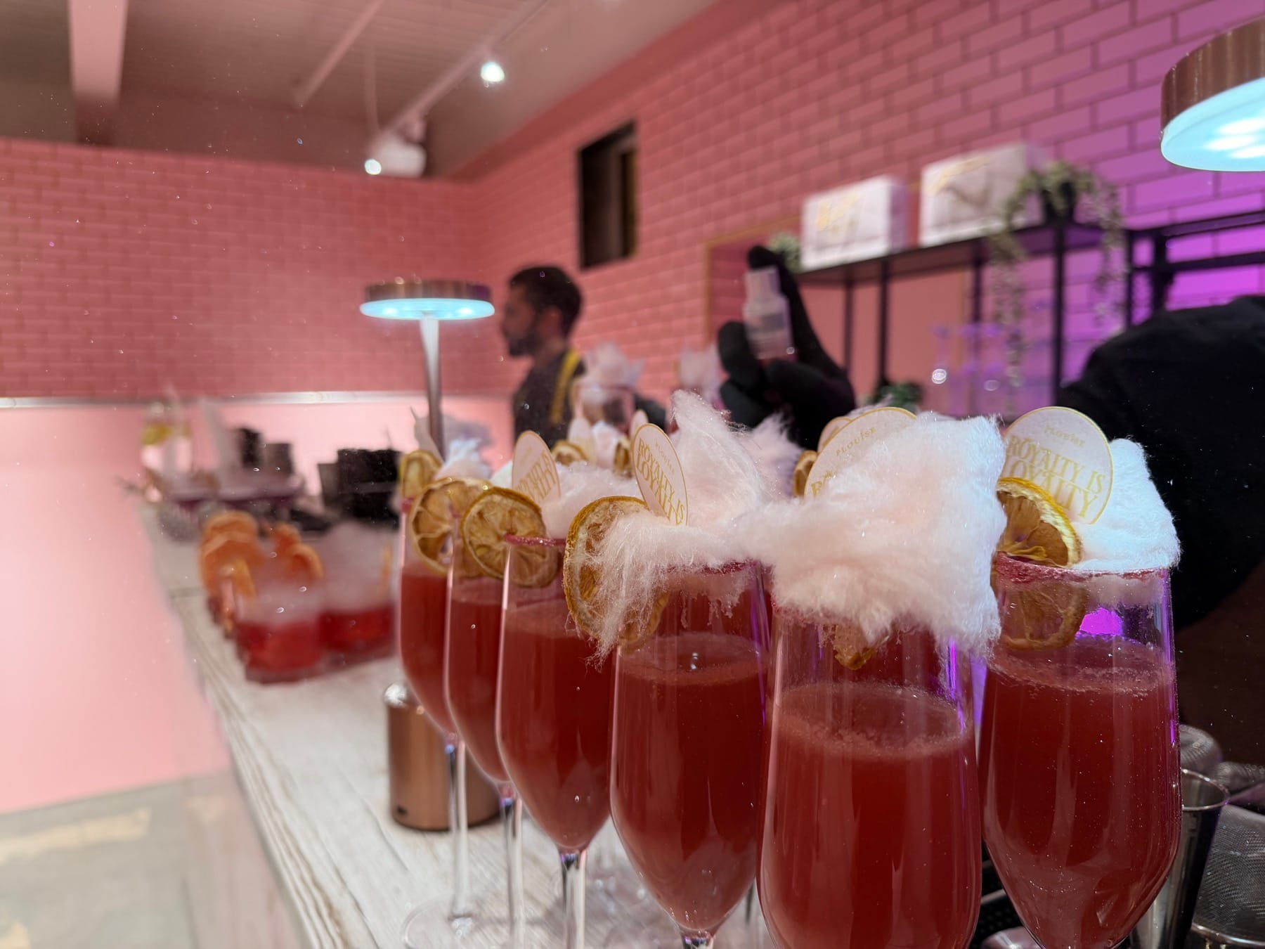 Pink P.Louise cocktails finished with candy floss and branded discs