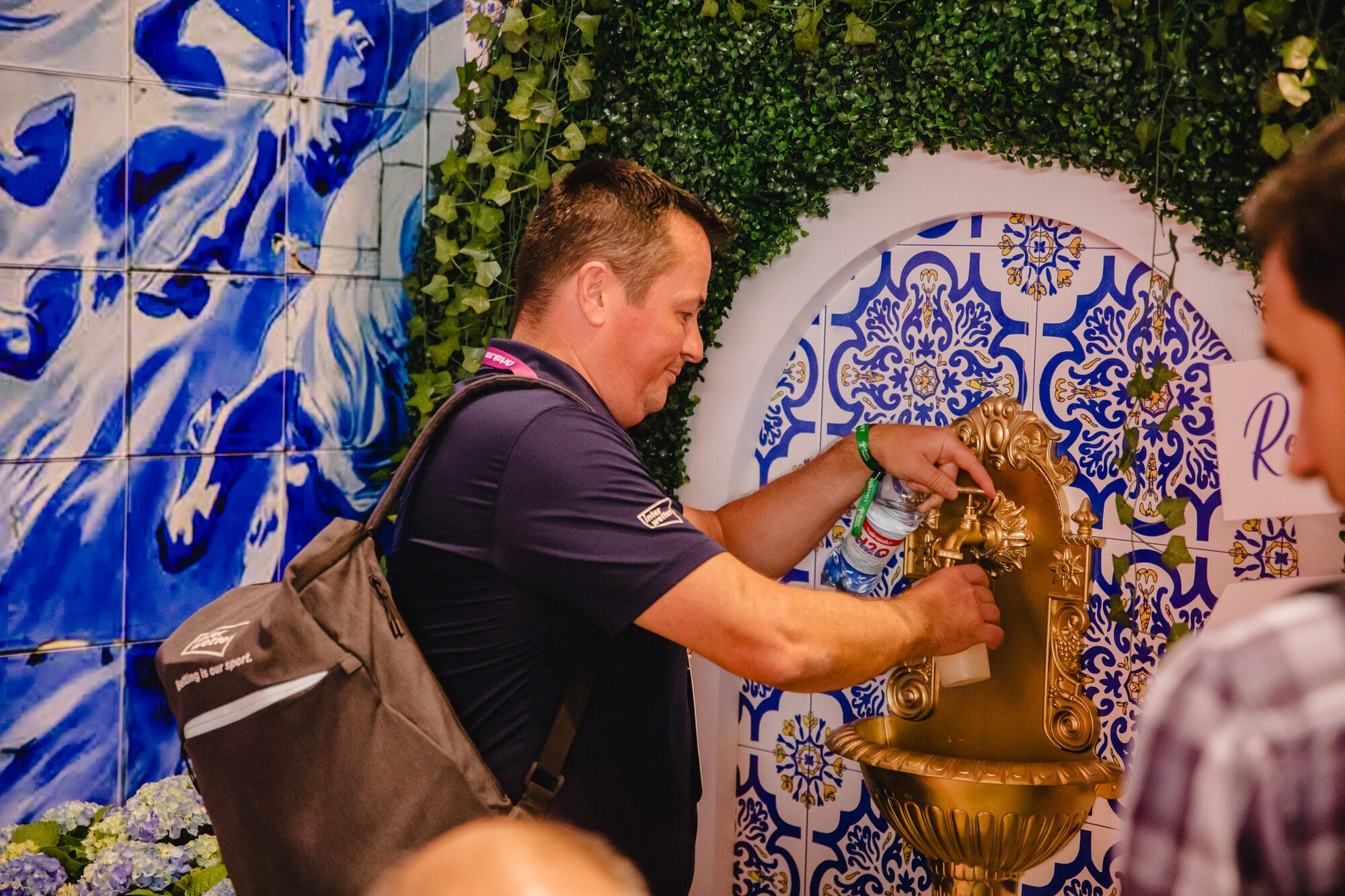 Gold fountain serve in the Mediterranean garden stand at SBC Summit, framed by Portuguese tiles and lemon trees
