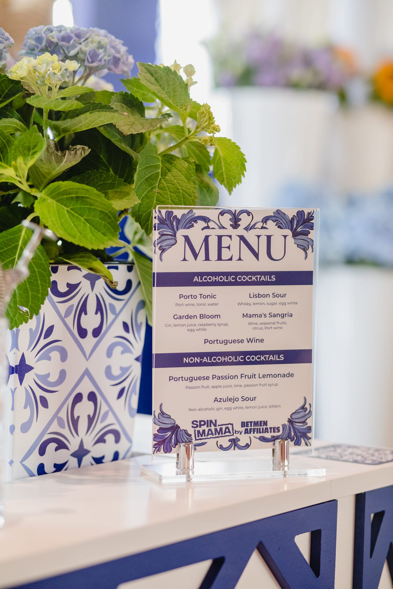 Bespoke cocktail menu for the SBC Summit stand listing Porto Tonic, Garden Bloom, Mama's Sangria and Azulejo Sour