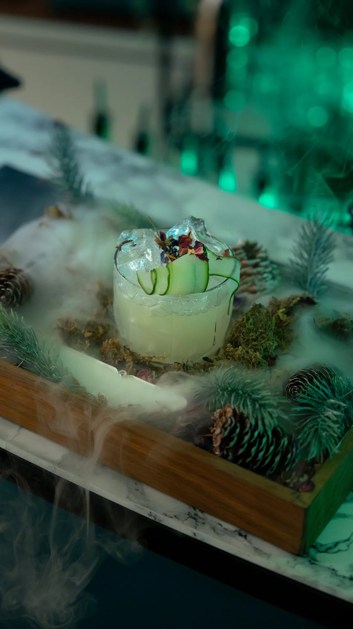 A signature green cocktail created for the Aston Martin launch, garnished and styled on a botanical display