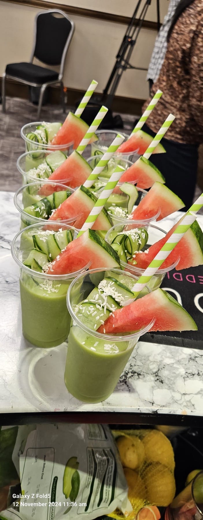 Tray of garnished green smoothies in branded cups served at a Softcat office roadshow