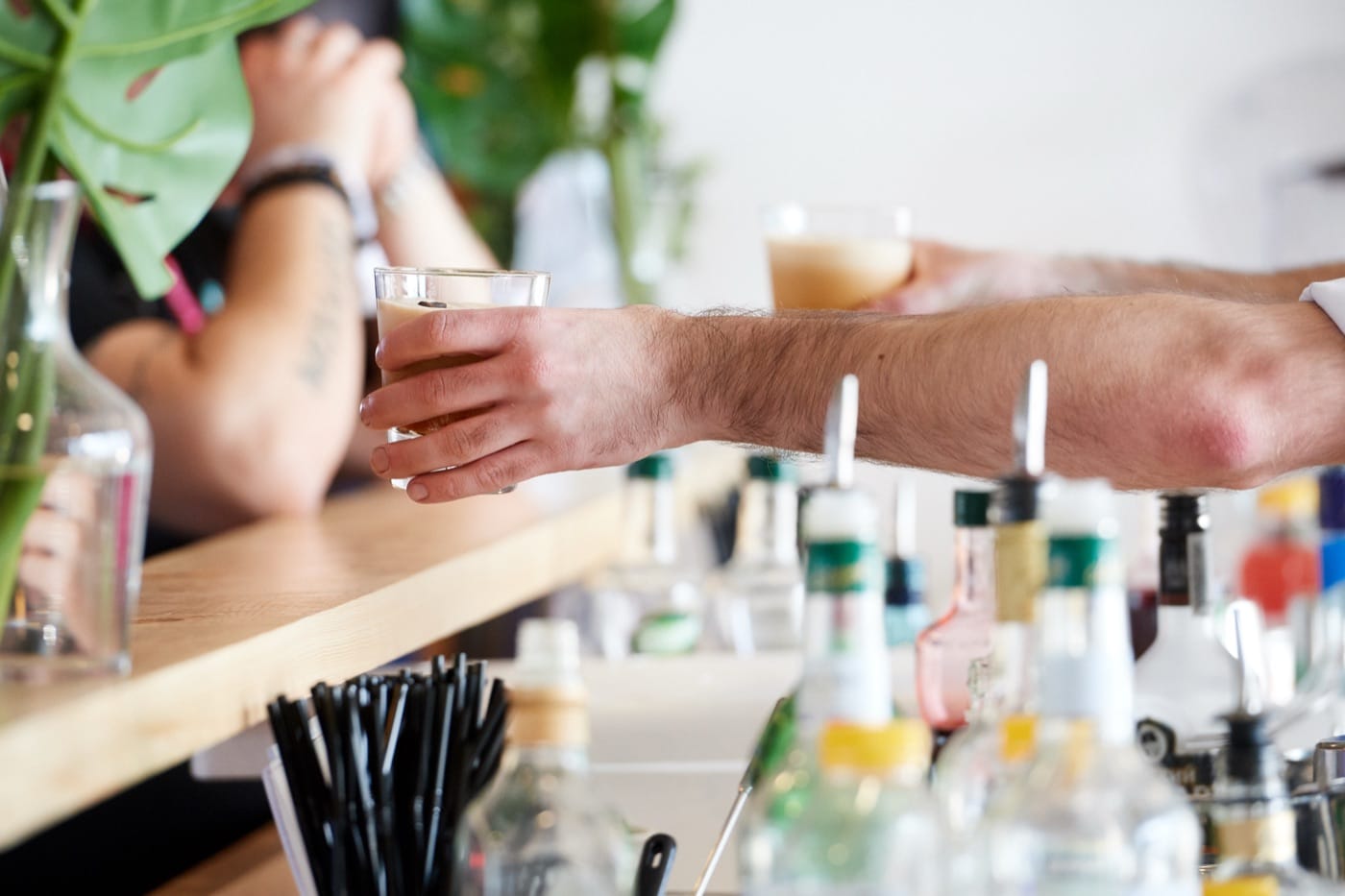 A Mr Flavour bartender serving fresh drinks across the bar in a Yas Marina suite at the Abu Dhabi Grand Prix