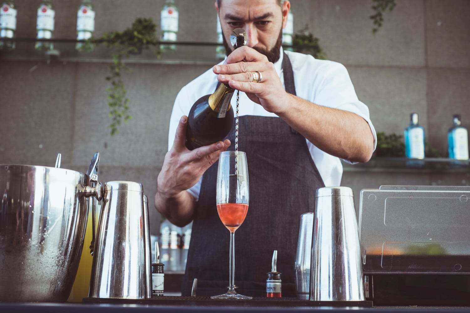 Mr Flavour bartender shaking a cocktail behind the Yas Trackside Terrace bar at the Abu Dhabi Grand Prix