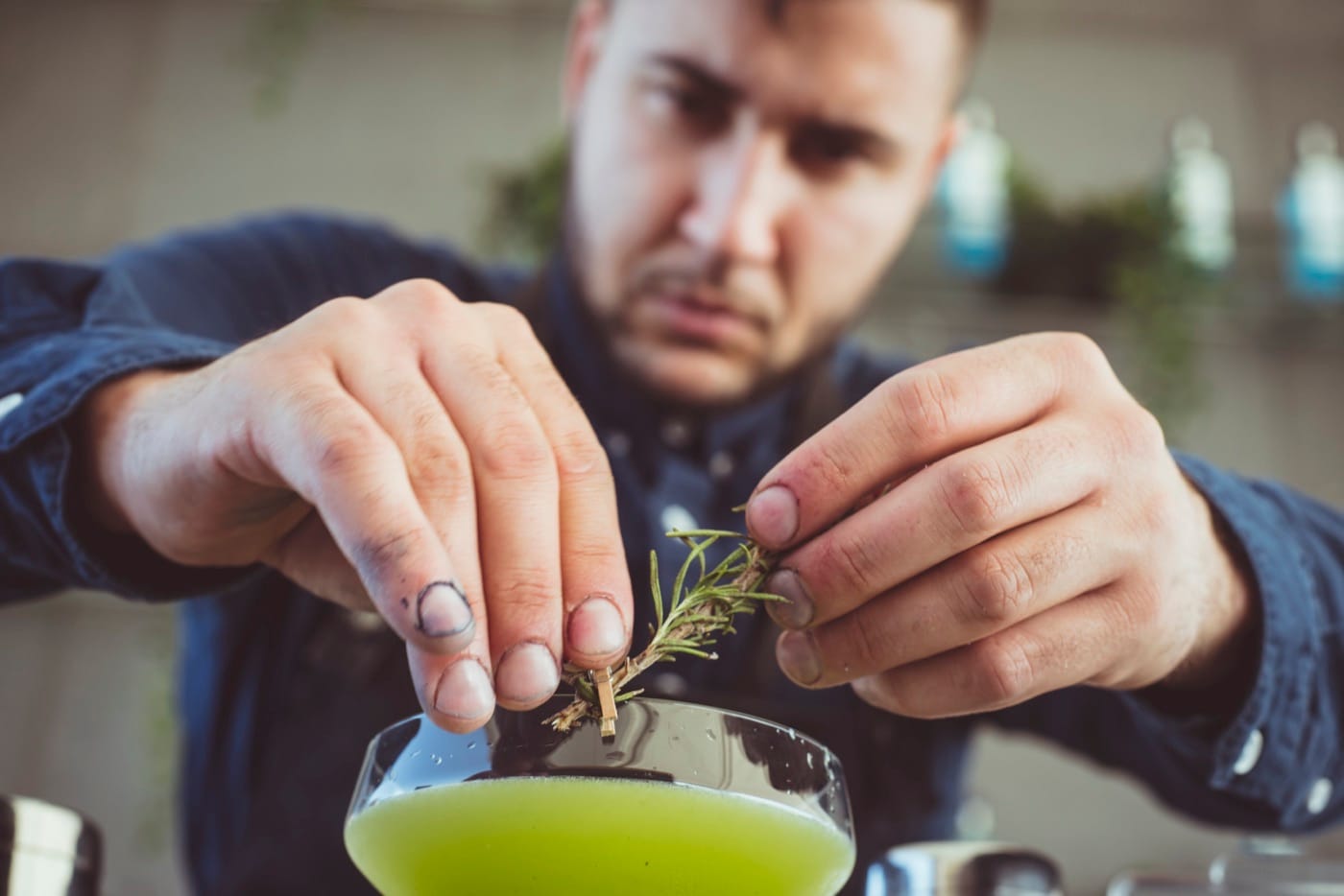 Mr Flavour bartender garnishing a cocktail with fresh rosemary at the Abu Dhabi Grand Prix