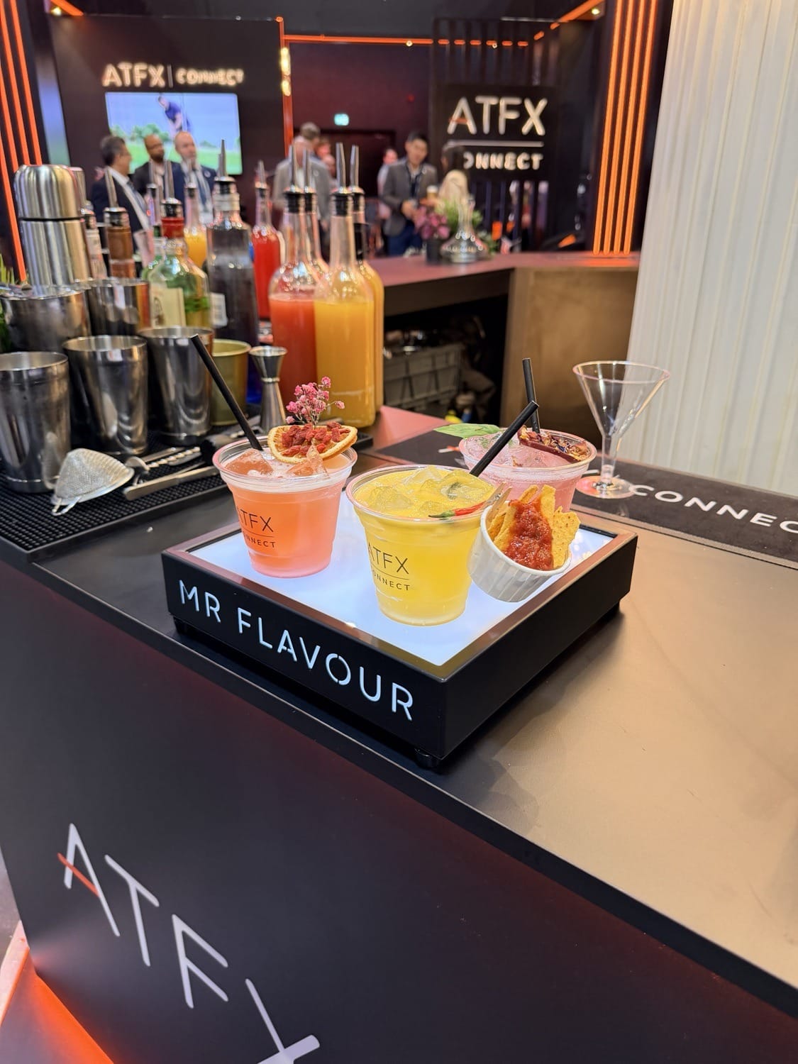 A trio of branded ATFX serves on the illuminated Mr Flavour tray at the Finance Magnates London Summit