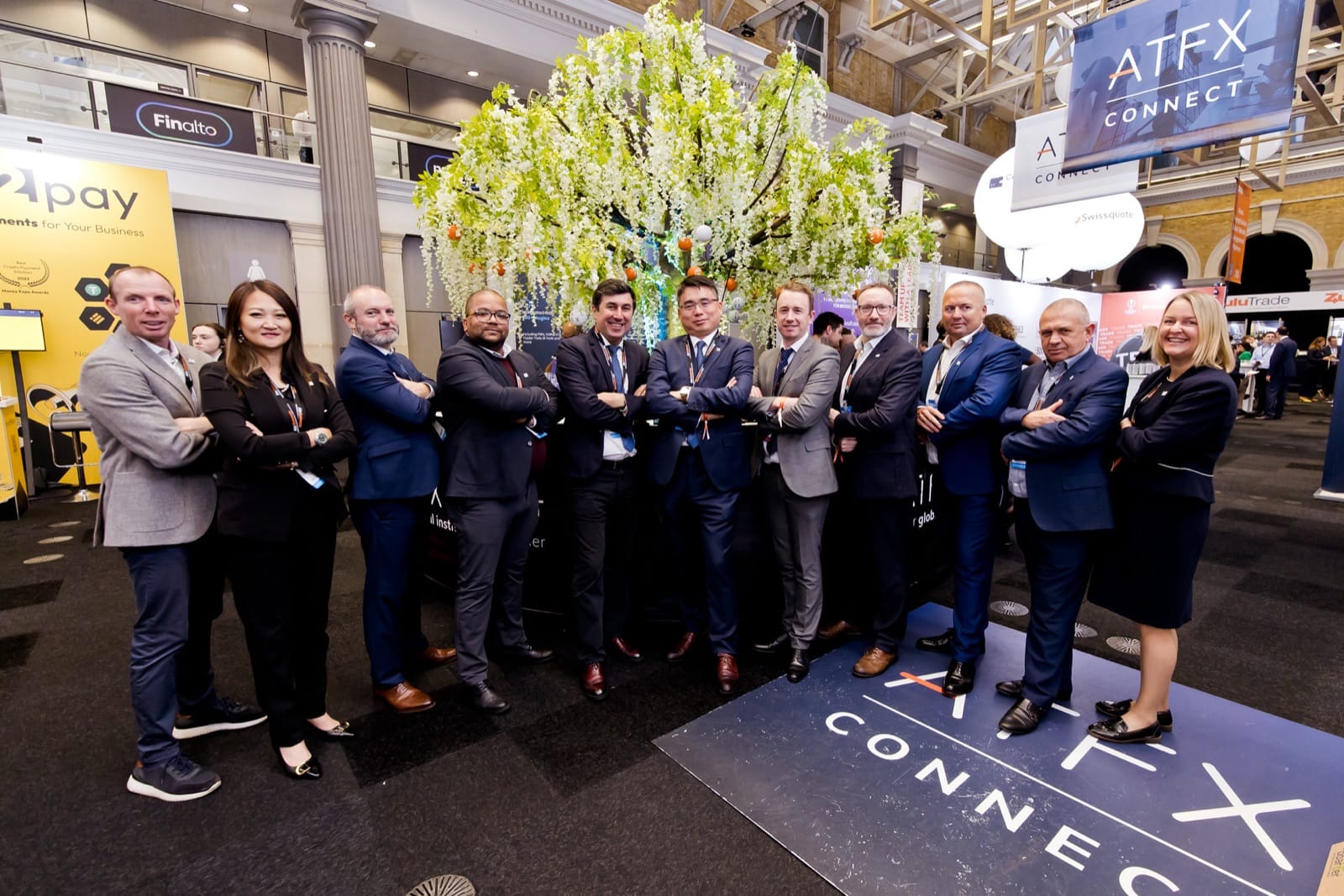 The Mr Flavour and ATFX Connect team at their branded exhibition stand at the Finance Magnates London Summit