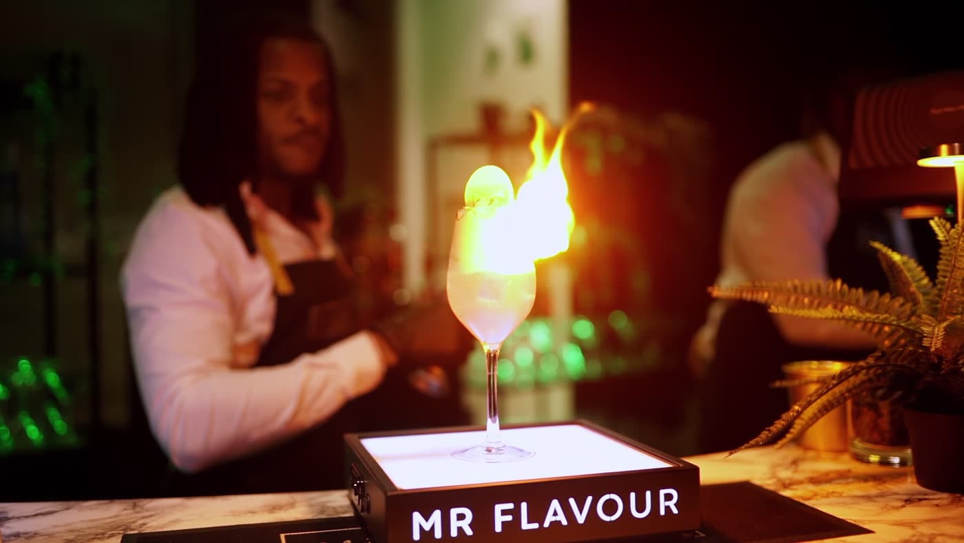A flaming serve poured on a lit Mr Flavour plinth